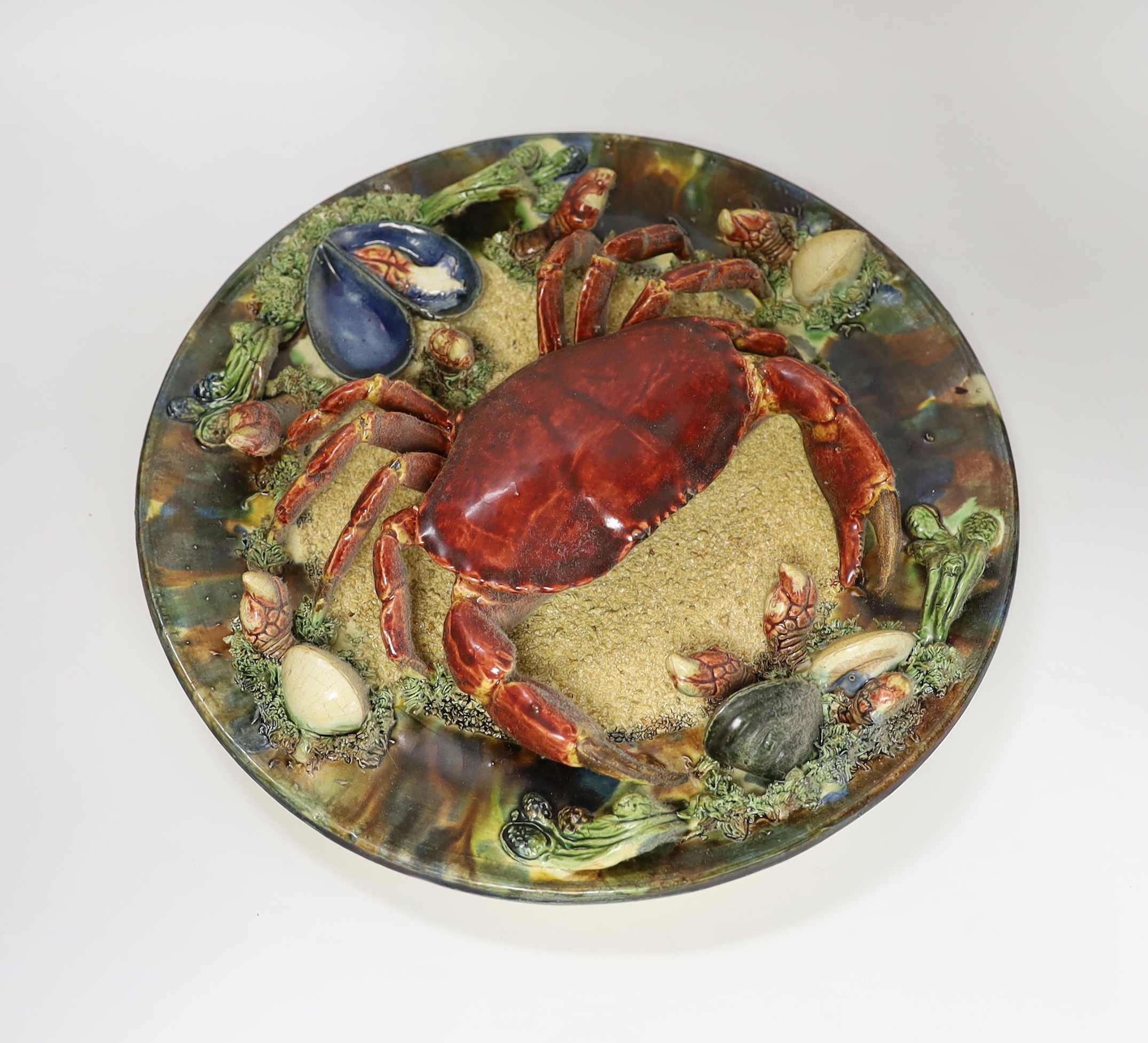 An Alvaro Jose Caldas Da Rainha Palissy ware dish, decorated in relief with a crab and shellfish, stamped to base, 31cm in diameter